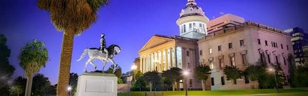 Statue of horseman in front of a historic building.
